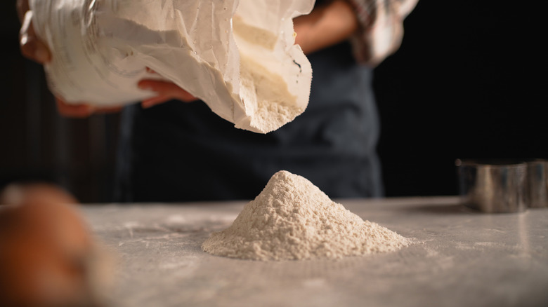 Pouring flour out of bag onto counter