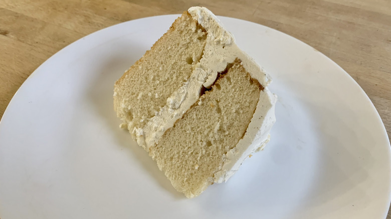 white cake slice slice on white plate with wood background