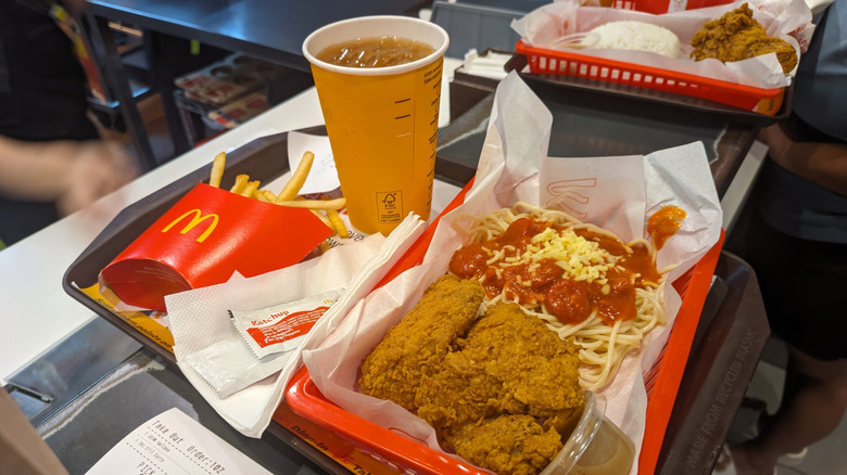 mcdonald's tray with fries, fried chicken, and spaghetti