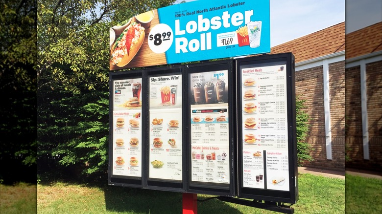 Mirrored image of McDonald's drive-thru menu with advert for lobster roll on top