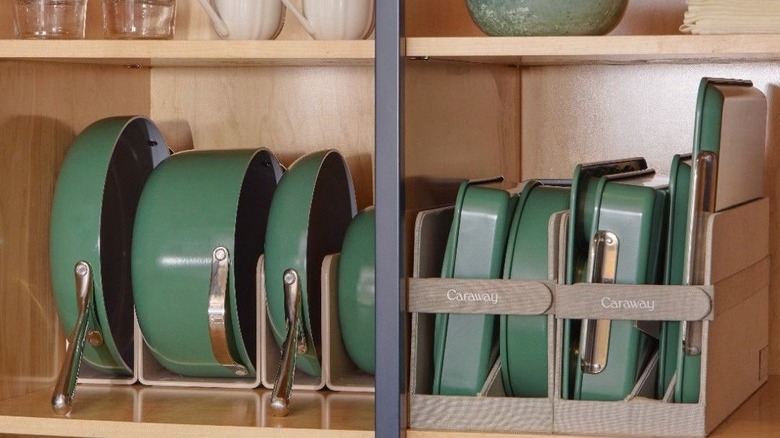 caraway pots and pans lined up in a wooden kitchen pantry