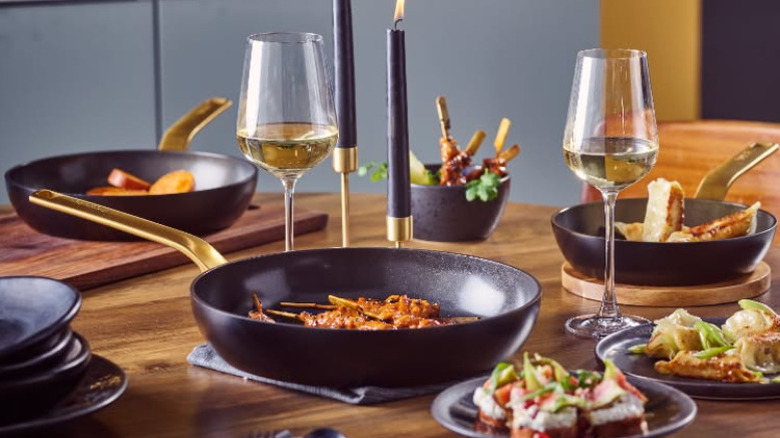 greenpan cookware beautifully set on a wooden dining table