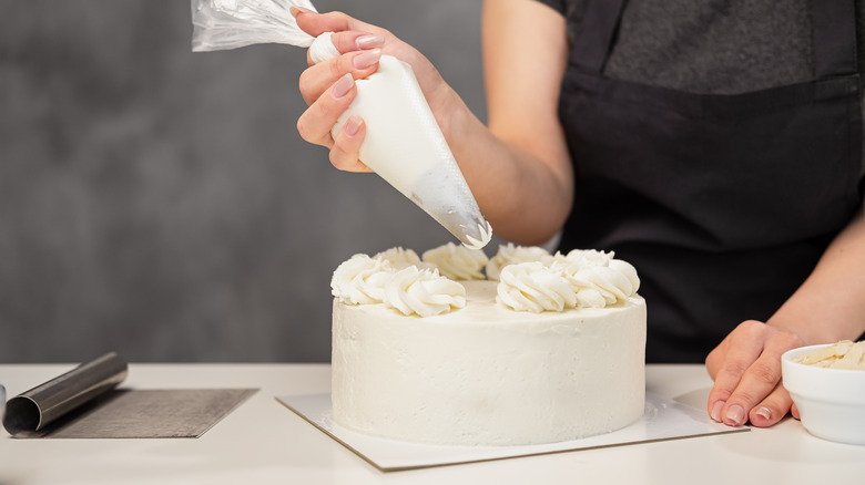 piping icing onto a cake