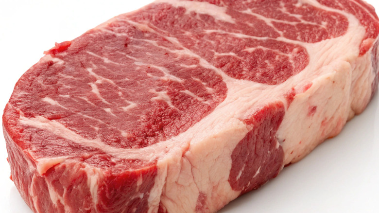 A raw piece of steak with marbling