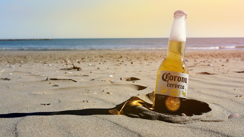 close up of Corona bottle on beach