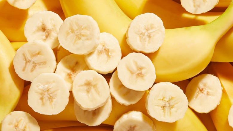 Sliced banana pieces over top of whole bananas