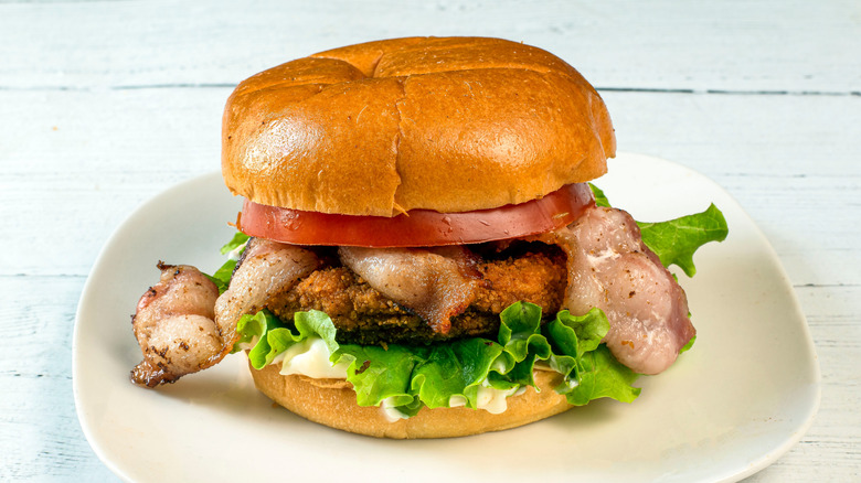 BLT with breaded fish on a Brioche bun