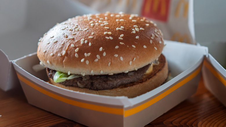 Close-up of a McDonald's burger in takeout box on table