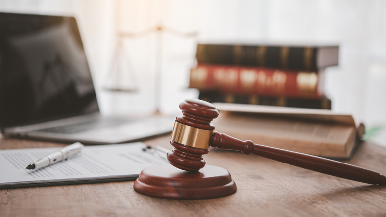 law signing with hammer on desk