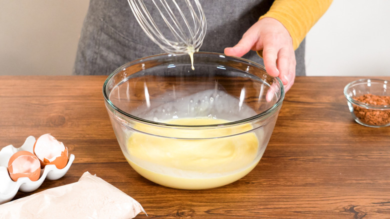 Hand mixing cake mix in a bowl