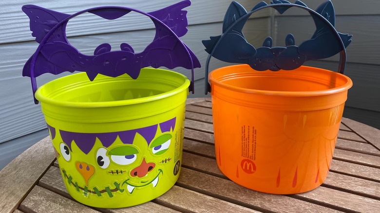 Orange and green McDonald's Boo Buckets on wooden table