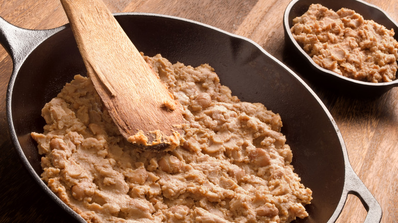wooden spoon in refried beans