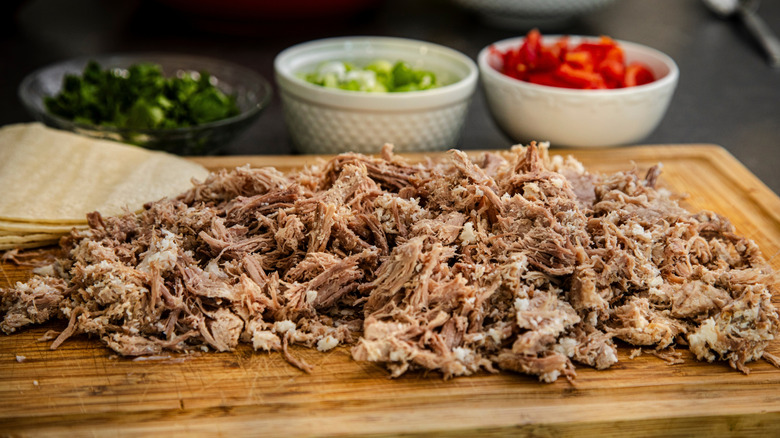 Chopped carnitas on cutting board