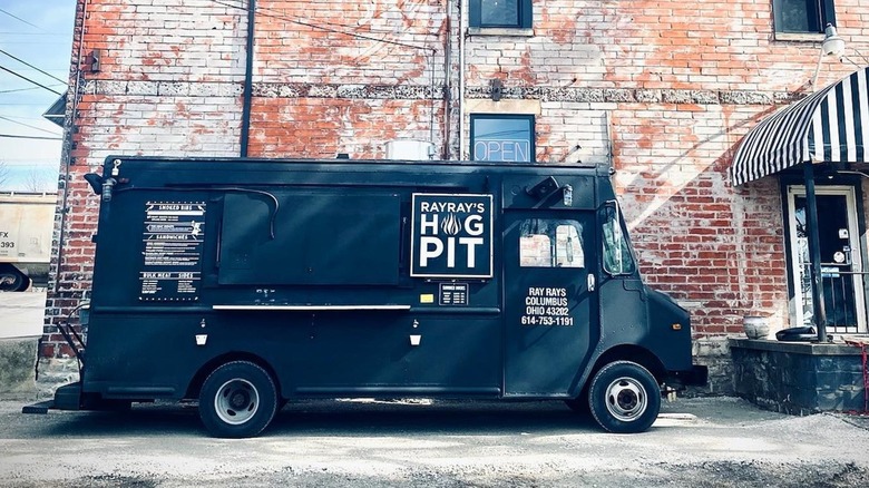 A wooden Ray Ray's Barbecue sign on a wall