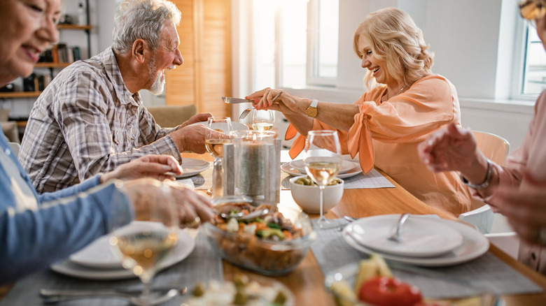 Mature adults eating together