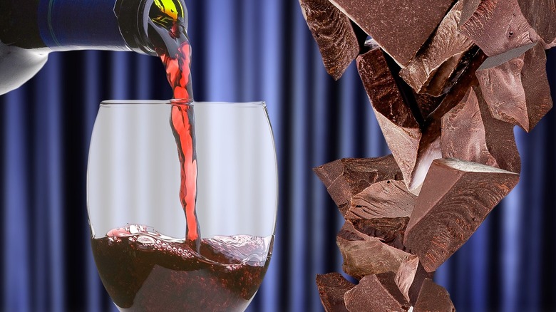 Red wine being poured from a bottle into a glass next to pieces of chocolate 