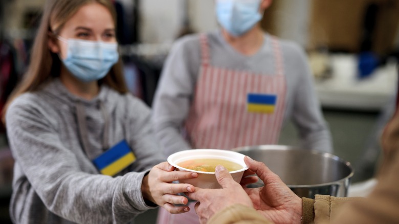 Ukraine refugees serving soup