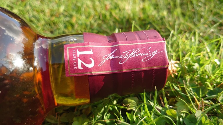 A close up of the neck of Aberlour 12 with the signature of James Fleming being shown