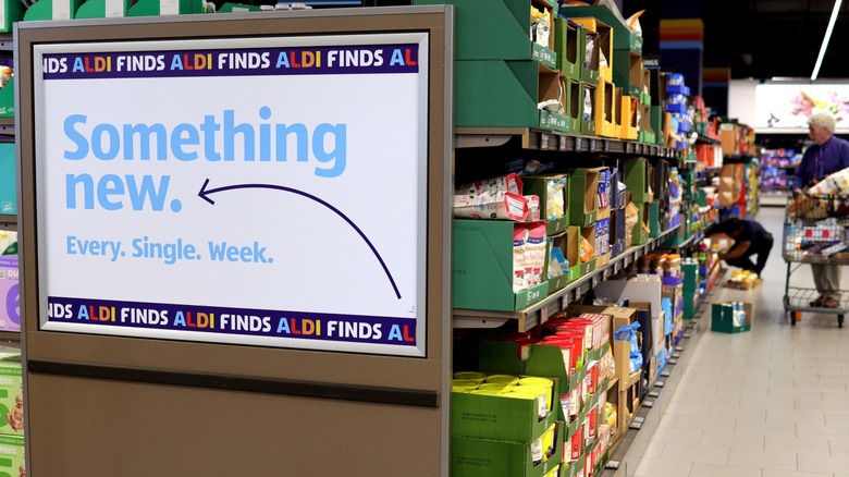 An Aldi shopping aisle with an advertising billboard
