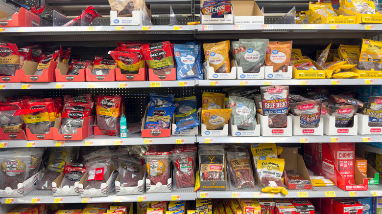 Many different beef jerky selections on a store shelf
