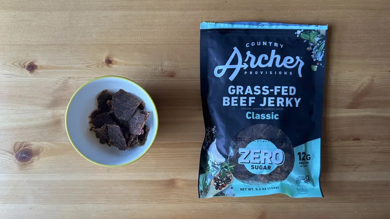 Country Archer Zero Sugar Classic Grass-Fed Beef Jerky in bag beside bowl