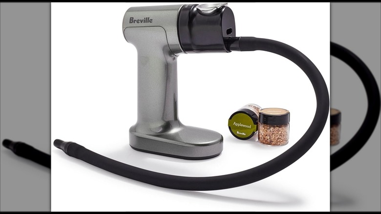 Mirrored image of Breville Smoking Gun with wood chips on white background