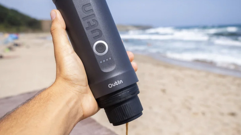 OutIn portable espresso machine on a beach