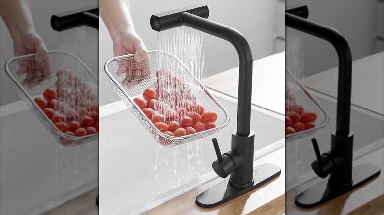 A person rinsing tomatoes with a Joom Waterfall kitchen faucet