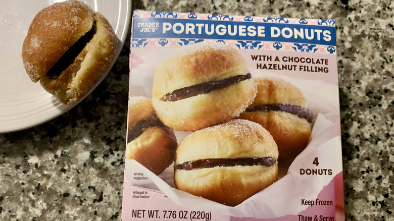 Box of Trader Joe's Portuguese donuts with one on a plate