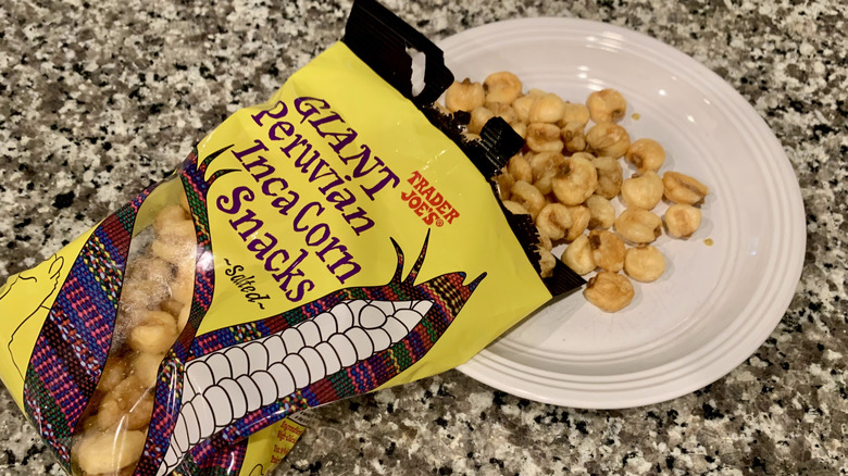 Opened bag of Trader Joe's Peruvian Inca Corn Snacks spilling out onto white plate