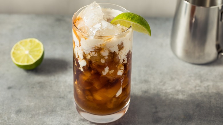 A dirty soda with coconut cream and a lime wedge