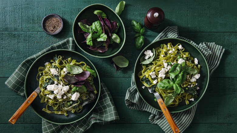 Bowls of pasta with greens