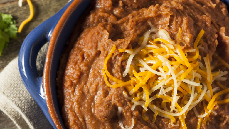 Refried beans topped with cheese