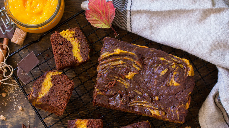 Overhead view of chocolate pumpkin cake on a cooling rack.