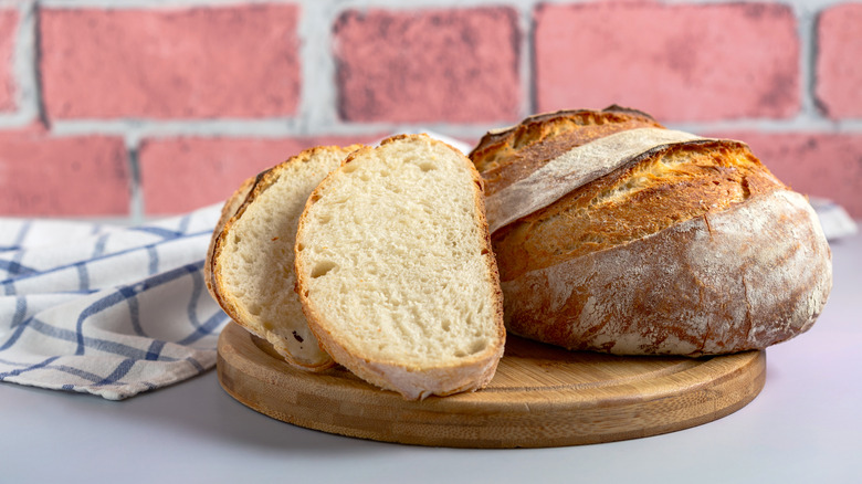 Sourdough slices with kitchen towel and brick background