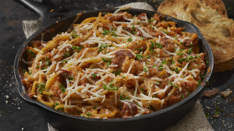 Pasta with sausage and cheese in skillet