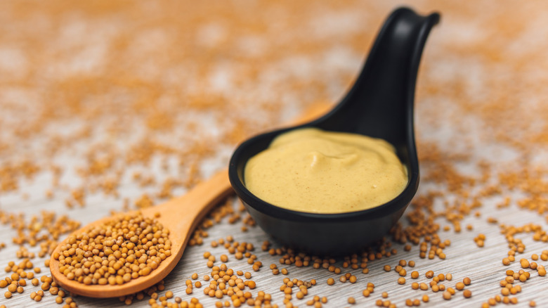 spoon of hot mustard with brown mustard seeds