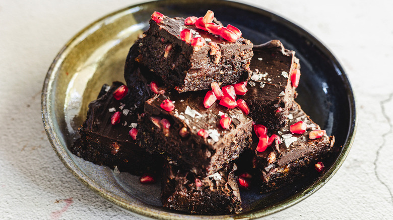 Batch of pomegranate brownies on plate 