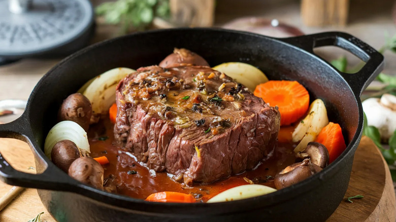Beef pot roast with carrots and root vegetables on a table