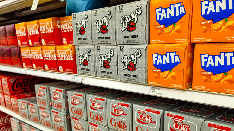 Soda brand 12-packs displayed on shelves