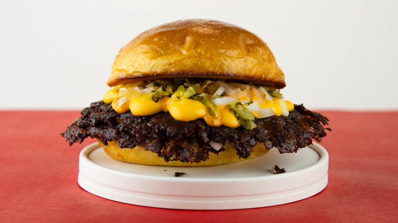 Smash burger with crust on plate