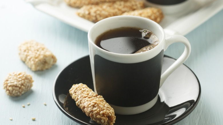black coffee served with sesame biscuits