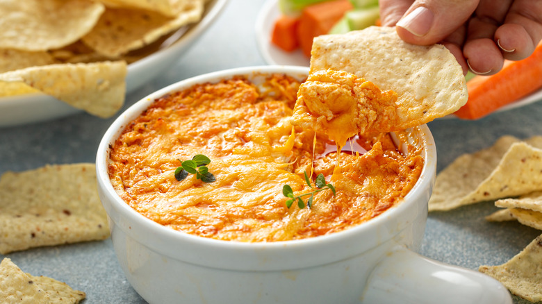 Buffalo chicken dip with tortilla chips and vegetables