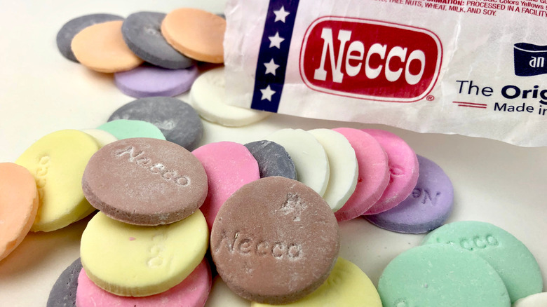 Round, colorful Necco Wafers with the paper package visible.