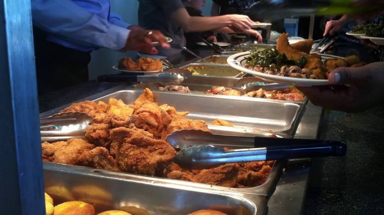 People serving themselves at the buffet at Martha's Place