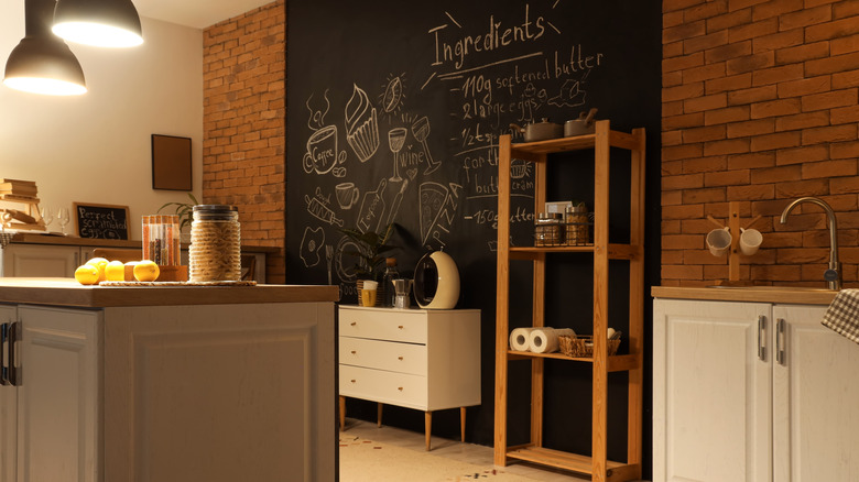 Interior of kitchen with chalkboard walls and neutral counters
