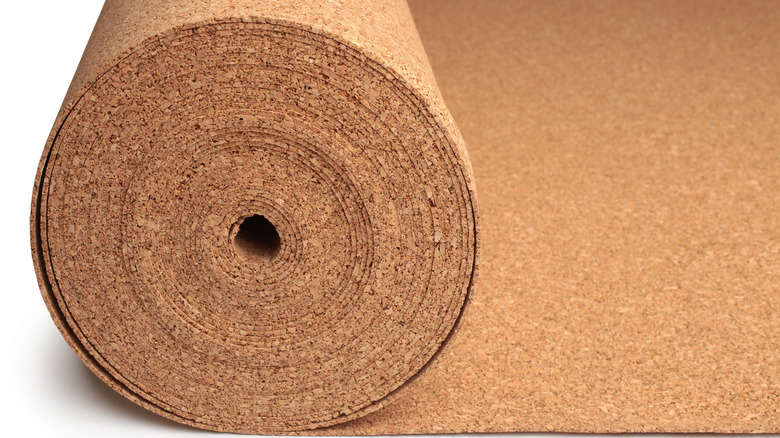 Roll of corkboard against white background