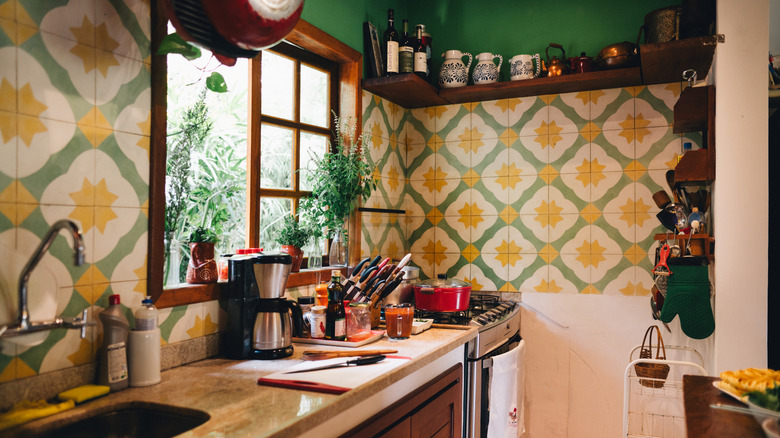 Kitchen interior with green and yellow floral walls
