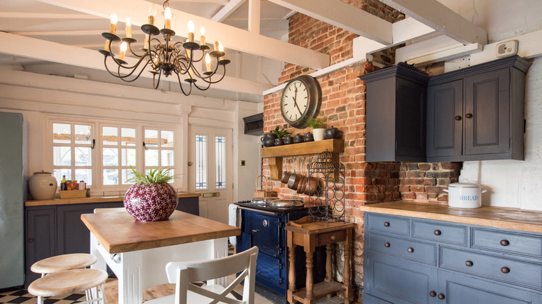 Cottage-style kitchen with exposed brick on the walls and backsplash