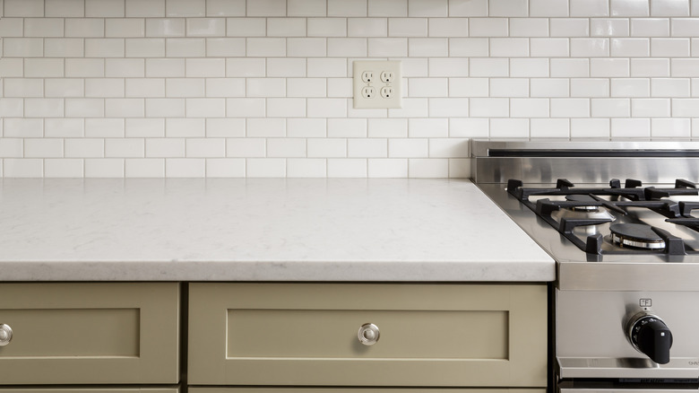 White kitchen counter with subway tiles on the backsplash